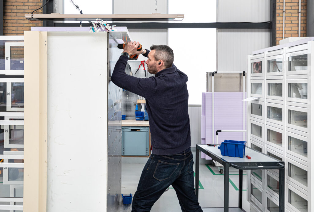 Technician performing the electrical wiring of the vending machine.