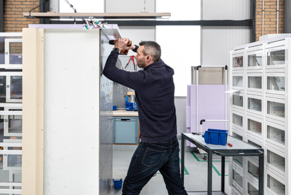 Technician performing the electrical wiring of the vending machine.