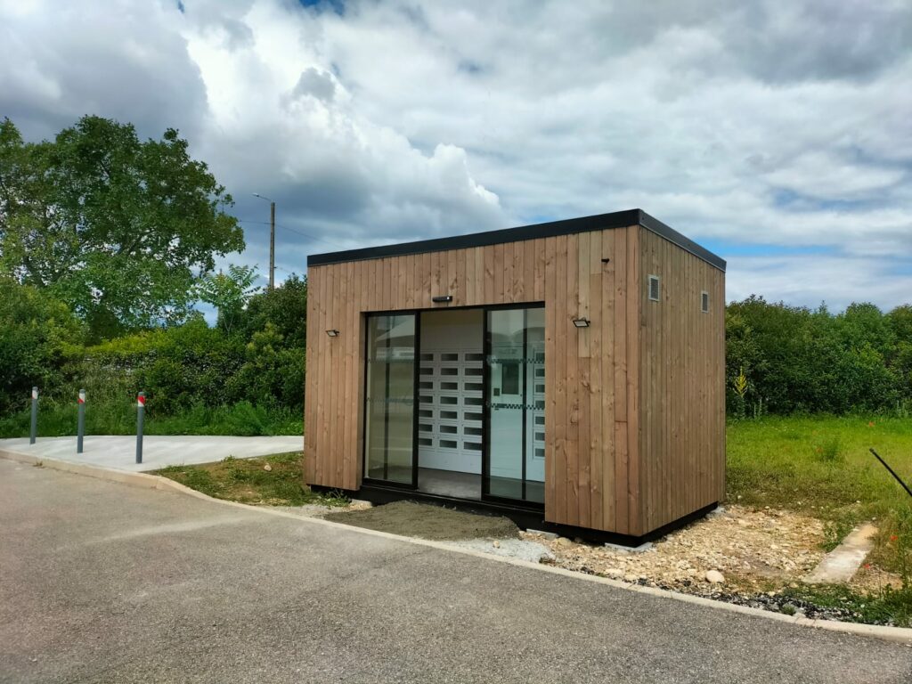Photo of a wooden modular building at a customer’s site creating a shop space around their vending machine