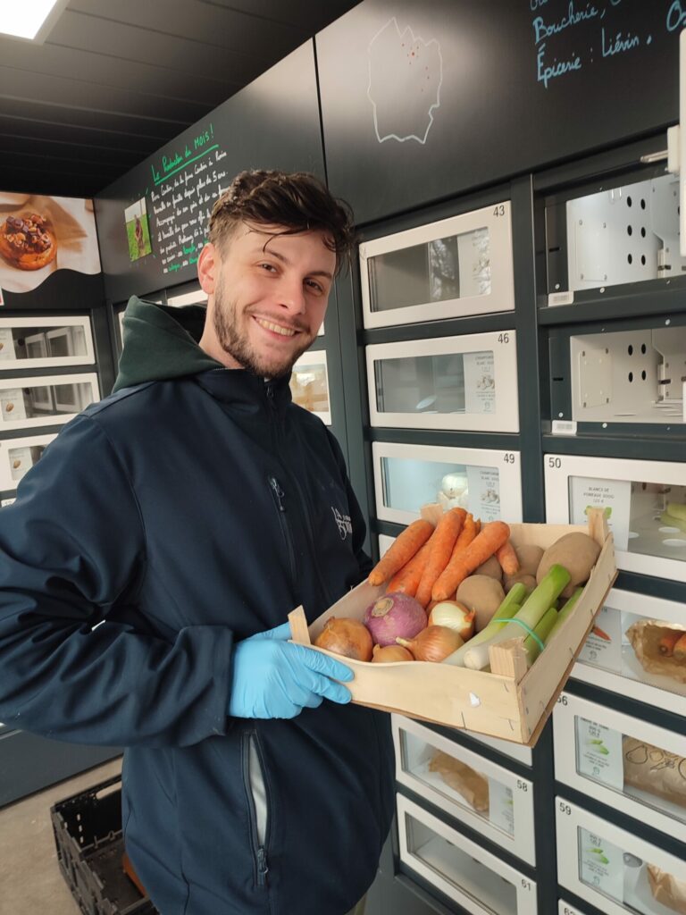 A delivery person restocks an Automat-e fresh food vending machine with fruit and vegetables.